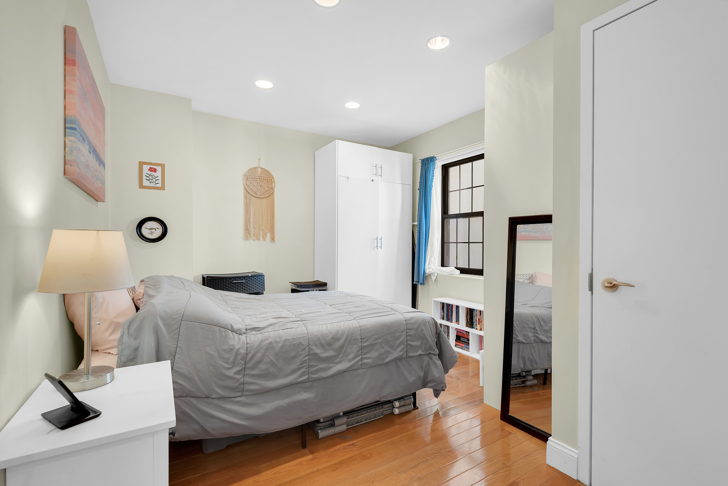 111 West 113th Street, Unit 3B Manhattan, NY 10026 - Photo 3 of 7 a bedroom with a bed and a lamp