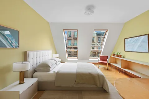 a view of walk in closet with clothes