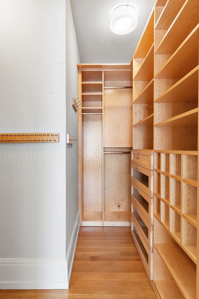 a view of walk in closet with empty racks