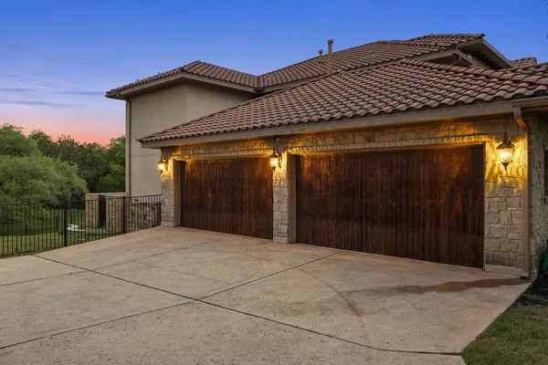 a kitchen with stainless steel appliances granite countertop a sink a stove and cabinets