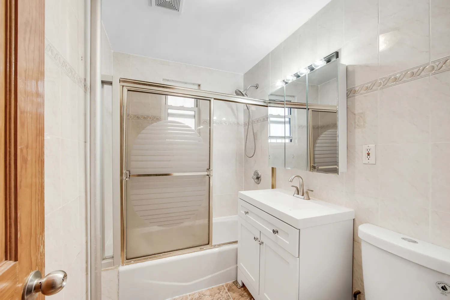 a bathroom with a double vanity sink a mirror and a shower