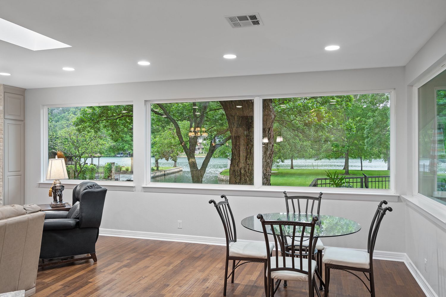a view of a dining room with furniture large windows and outside view