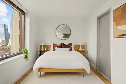 a bed sitting in a bedroom next to a window