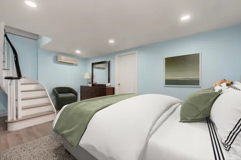 a bedroom with a bed and a television