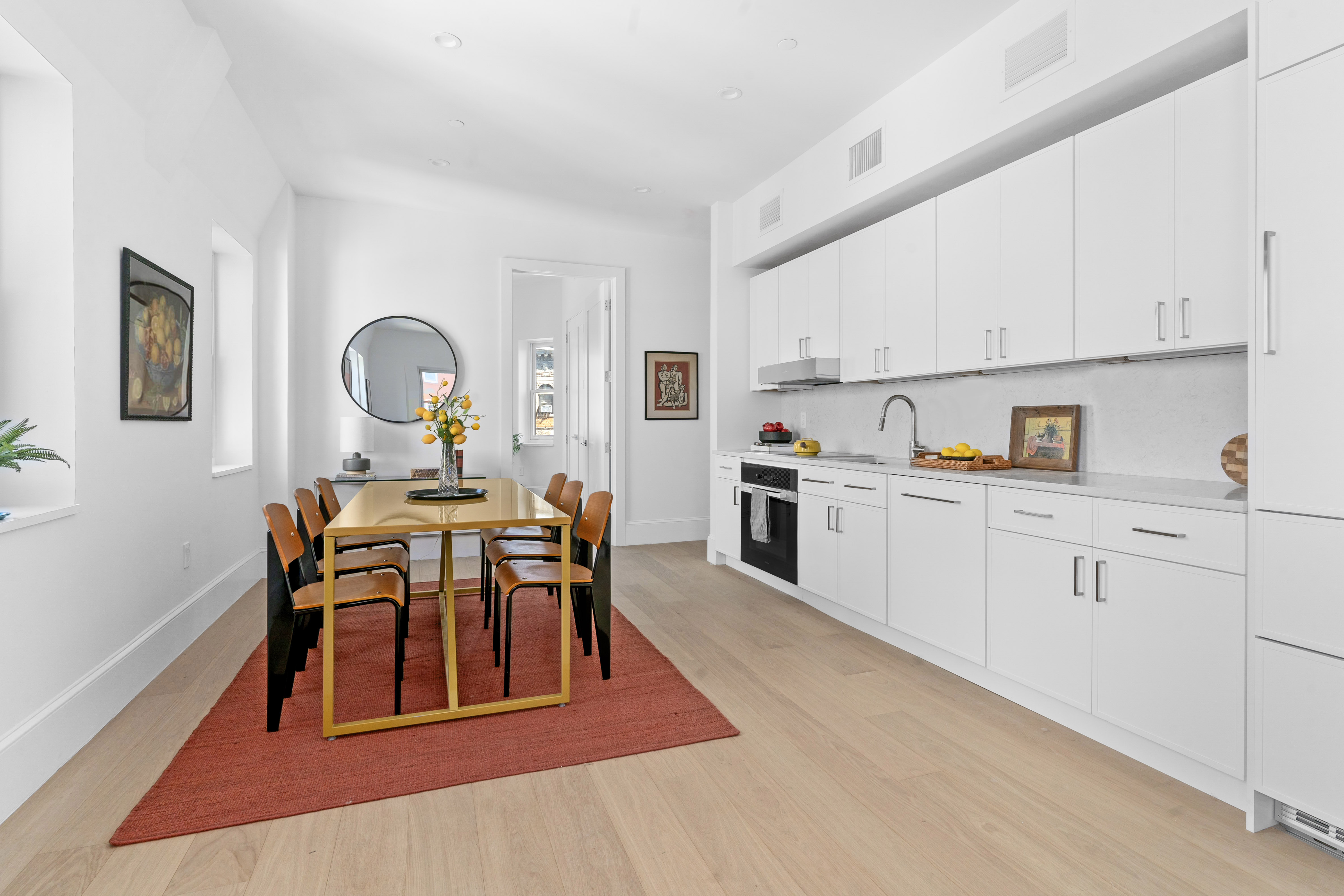 1370 Dean Street, Unit PHD Brooklyn, NY 11216 - Photo 6 of 13 a view of kitchen with cabinets table and chairs