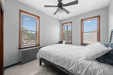 a bedroom with a bed dresser and a window