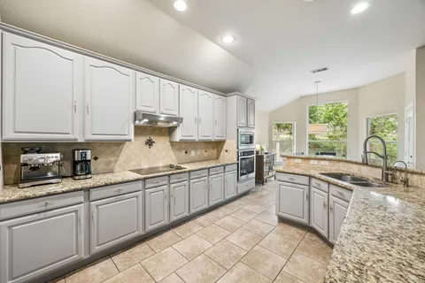 a kitchen with sink cabinets and window