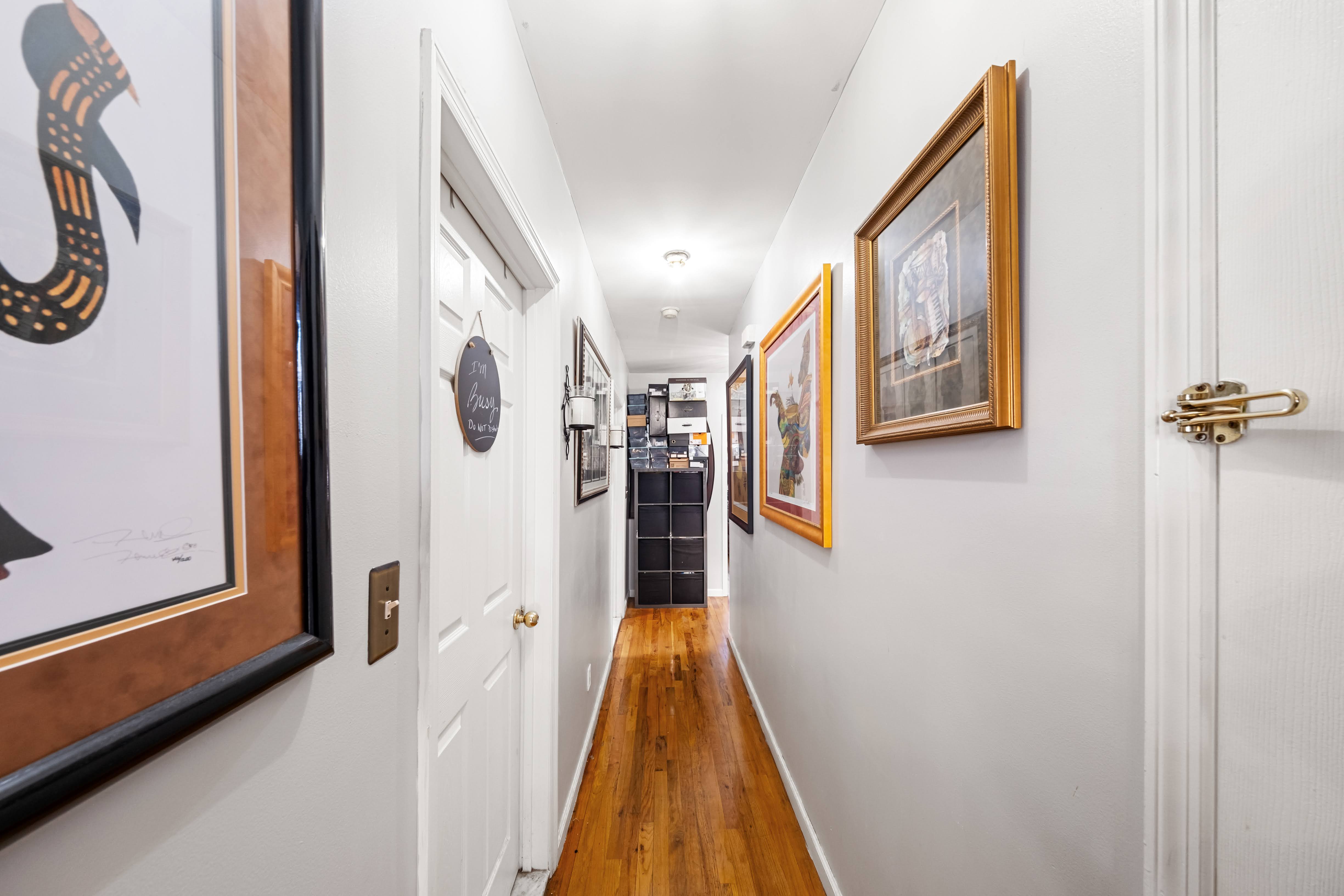 275 Van Buren Street Brooklyn, NY 11221 - Photo 9 of 33 a view of a hallway with paintings on the wall