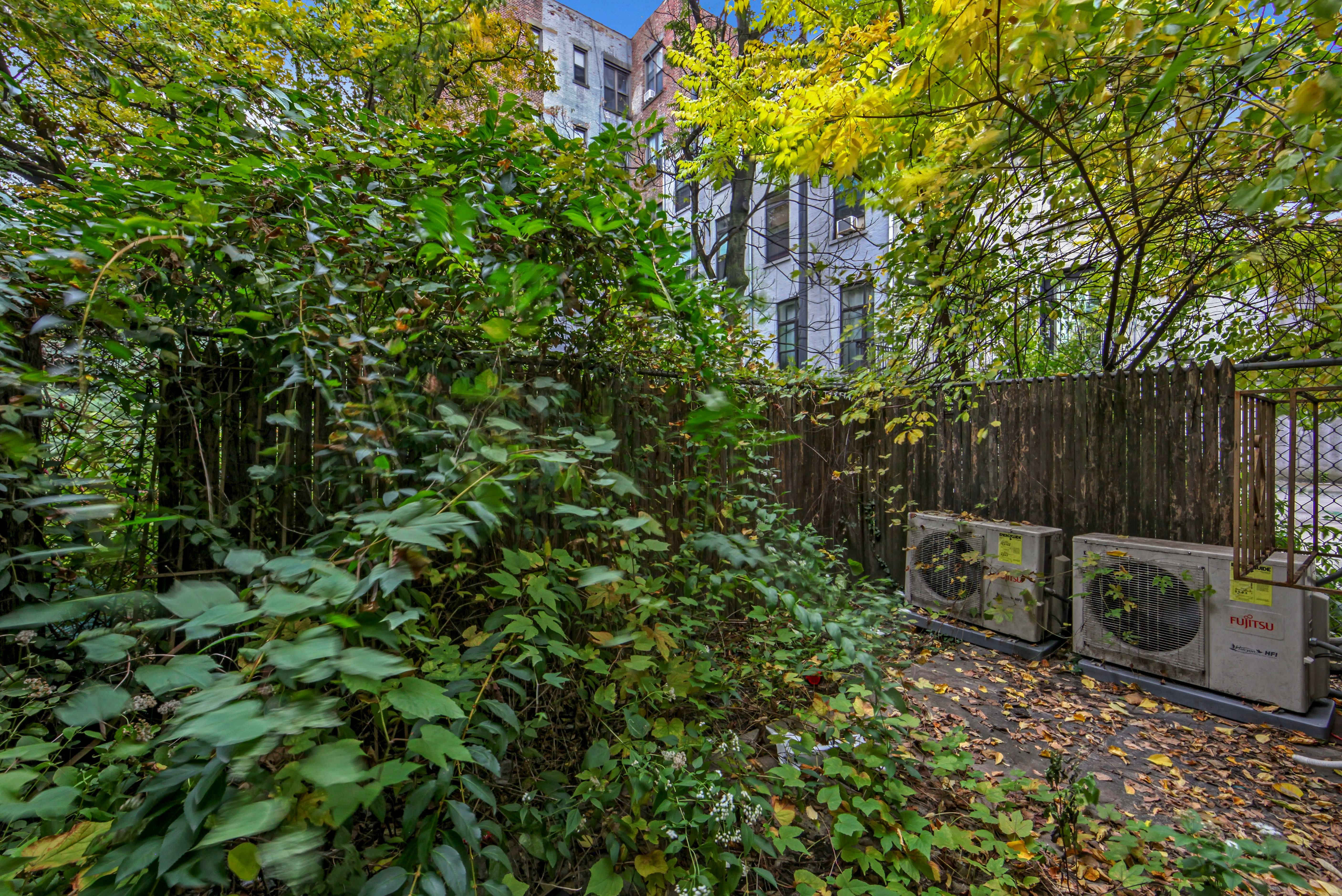 430 Lenox Avenue, Unit 1 Manhattan, NY 10037 - Photo 5 of 14 a backyard of a house with lots of green space
