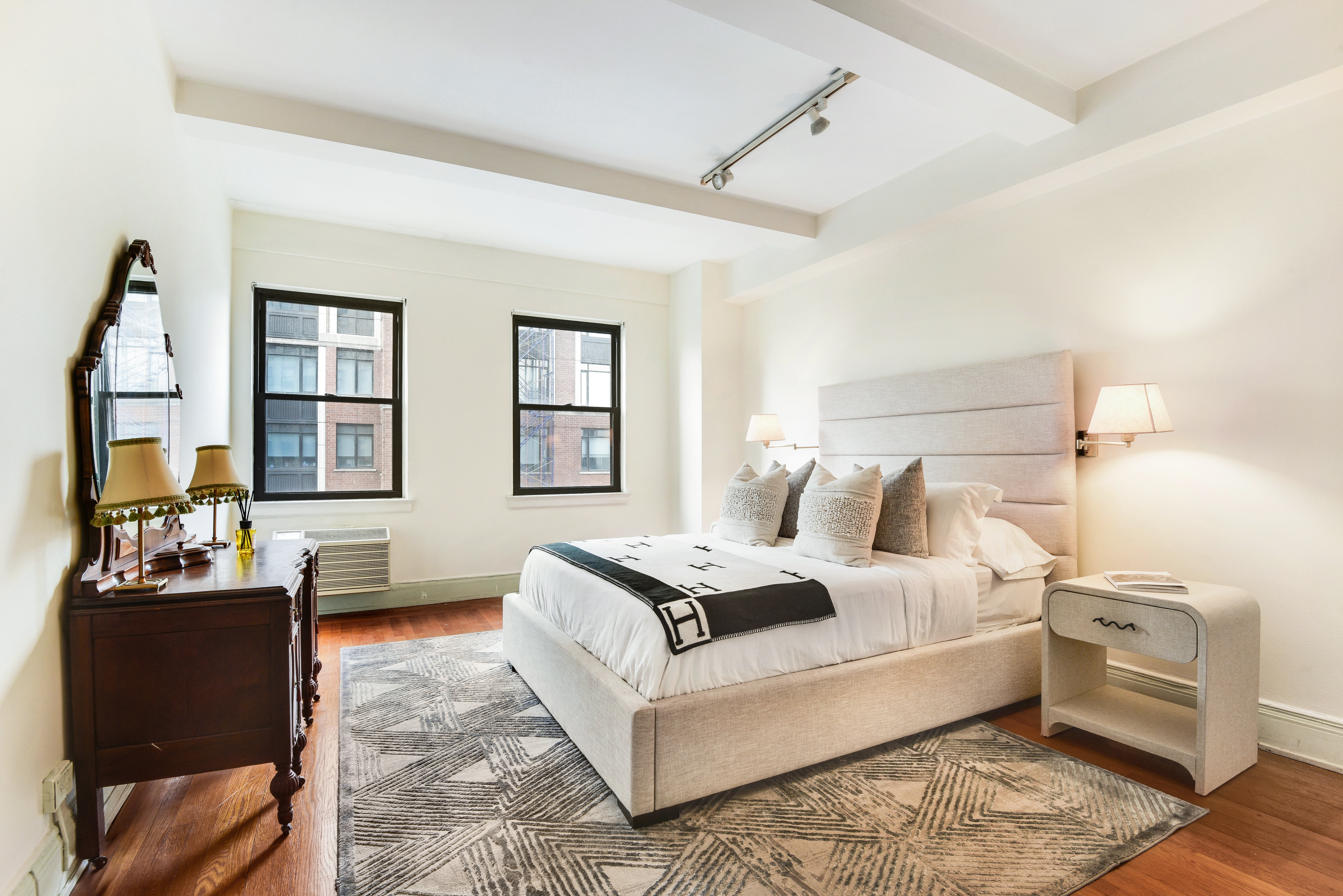 49 East 96th Street, Unit 8/9E Manhattan, NY 10128 - Photo 9 of 17 a living room with furniture and a flat screen tv