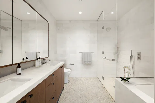 a bathroom with double vanity sink and a mirror