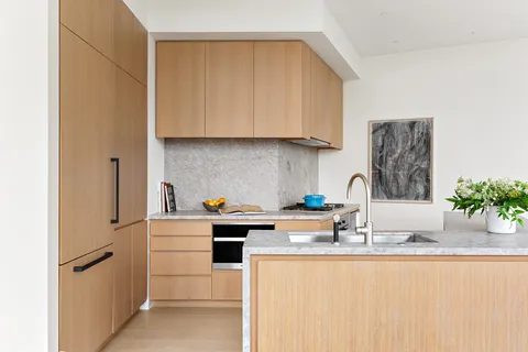 a kitchen with stainless steel appliances granite countertop a sink stove and cabinets