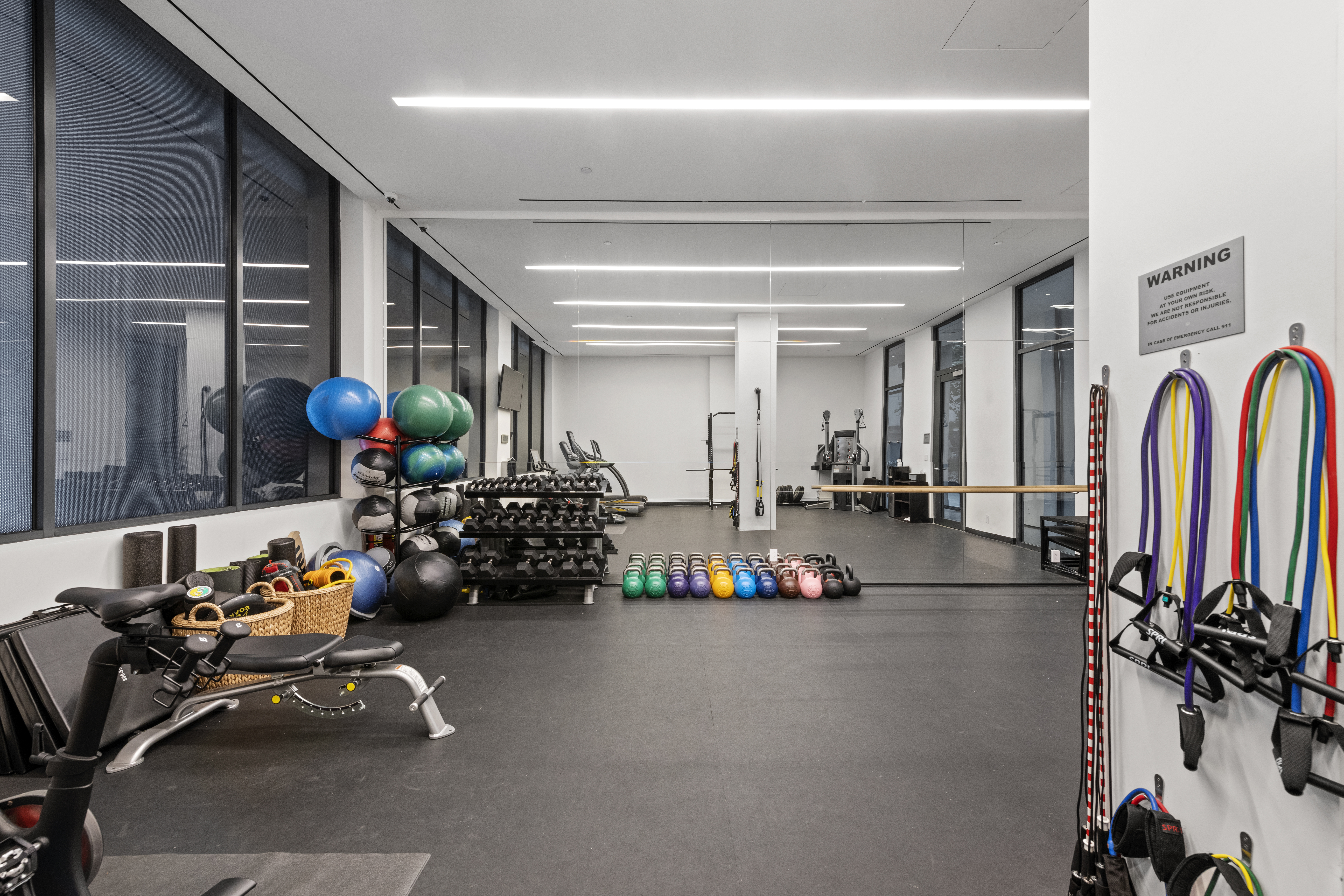 11 North Moore Street, Unit 2B Manhattan, NY 10013 - Photo 9 of 12 a room with gym equipment and a large window