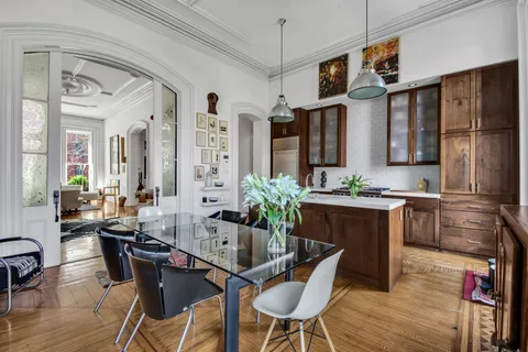 a dining room with furniture a chandelier and wooden floor
