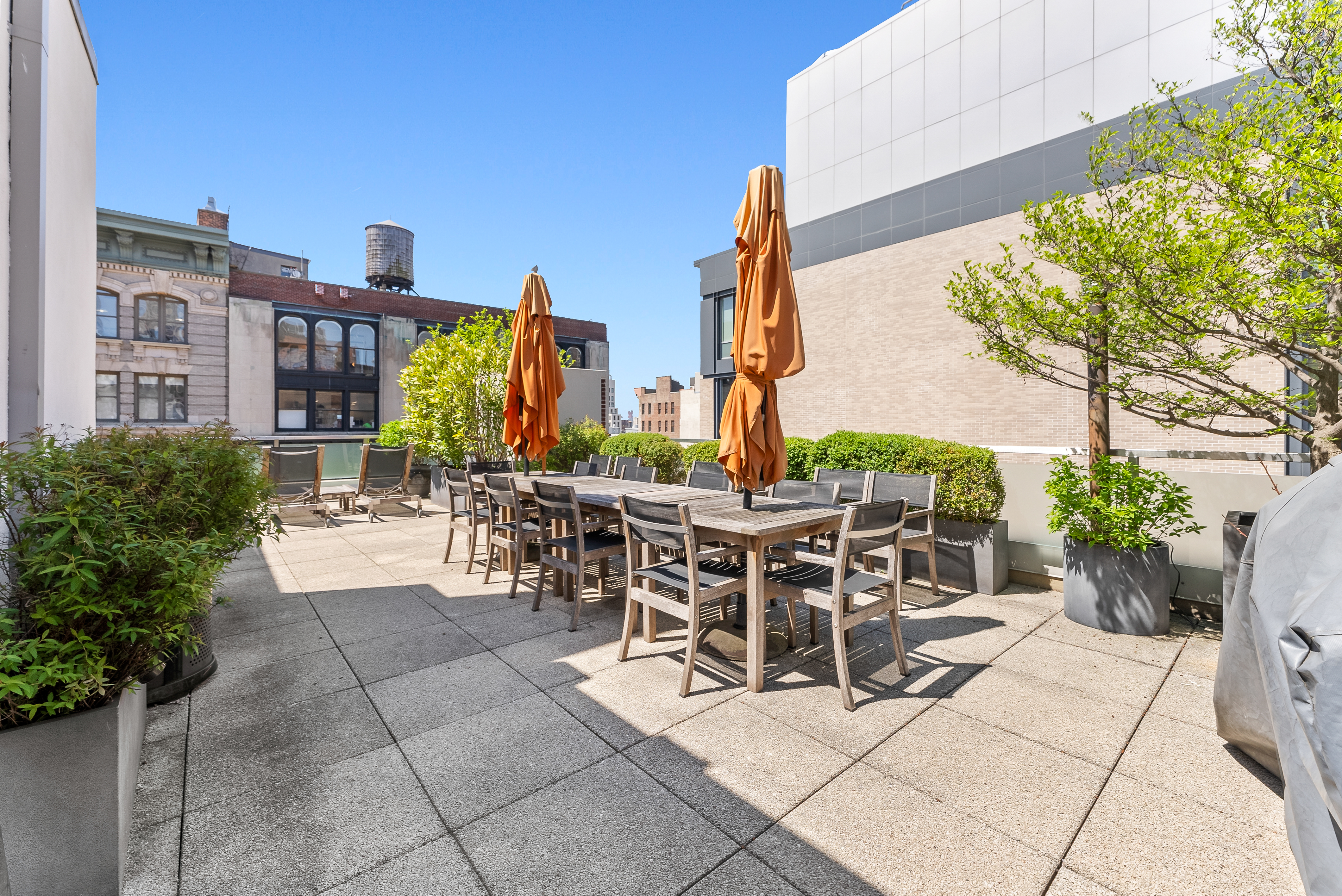 15 West 20th Street, Unit 9A Manhattan, NY 10011 - Photo 20 of 21 a view of a patio with dining table and chairs potted plants