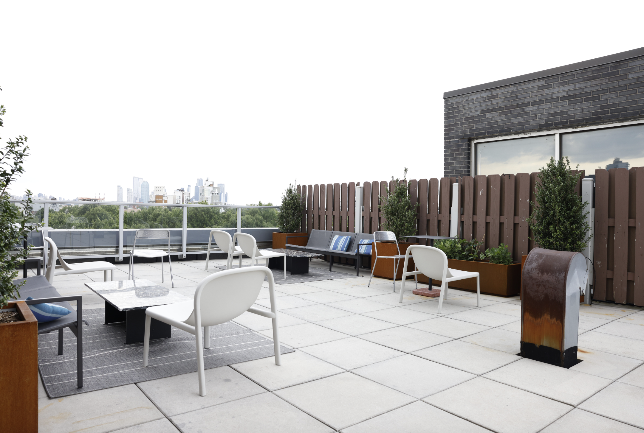 50 Bayard Street, Unit 1B Brooklyn, NY 11211 - Photo 11 of 13 a view of backyard with a table and chairs couches with wooden fence