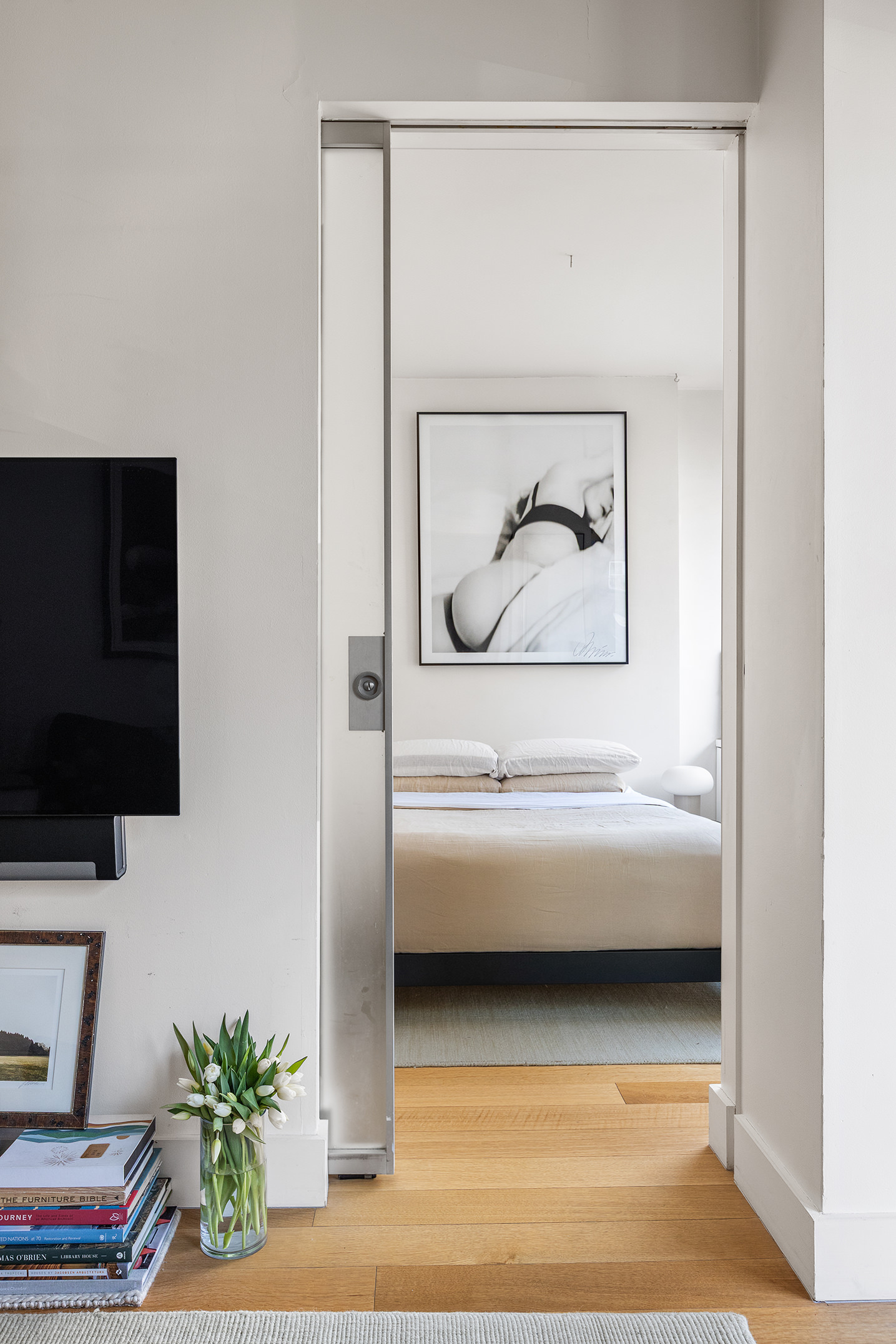 425 East 13th Street, Unit 3F Manhattan, NY 10009 - Photo 8 of 16 a living room with furniture and a flat screen tv