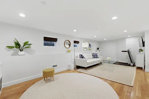 a bedroom with a bed and a potted plant