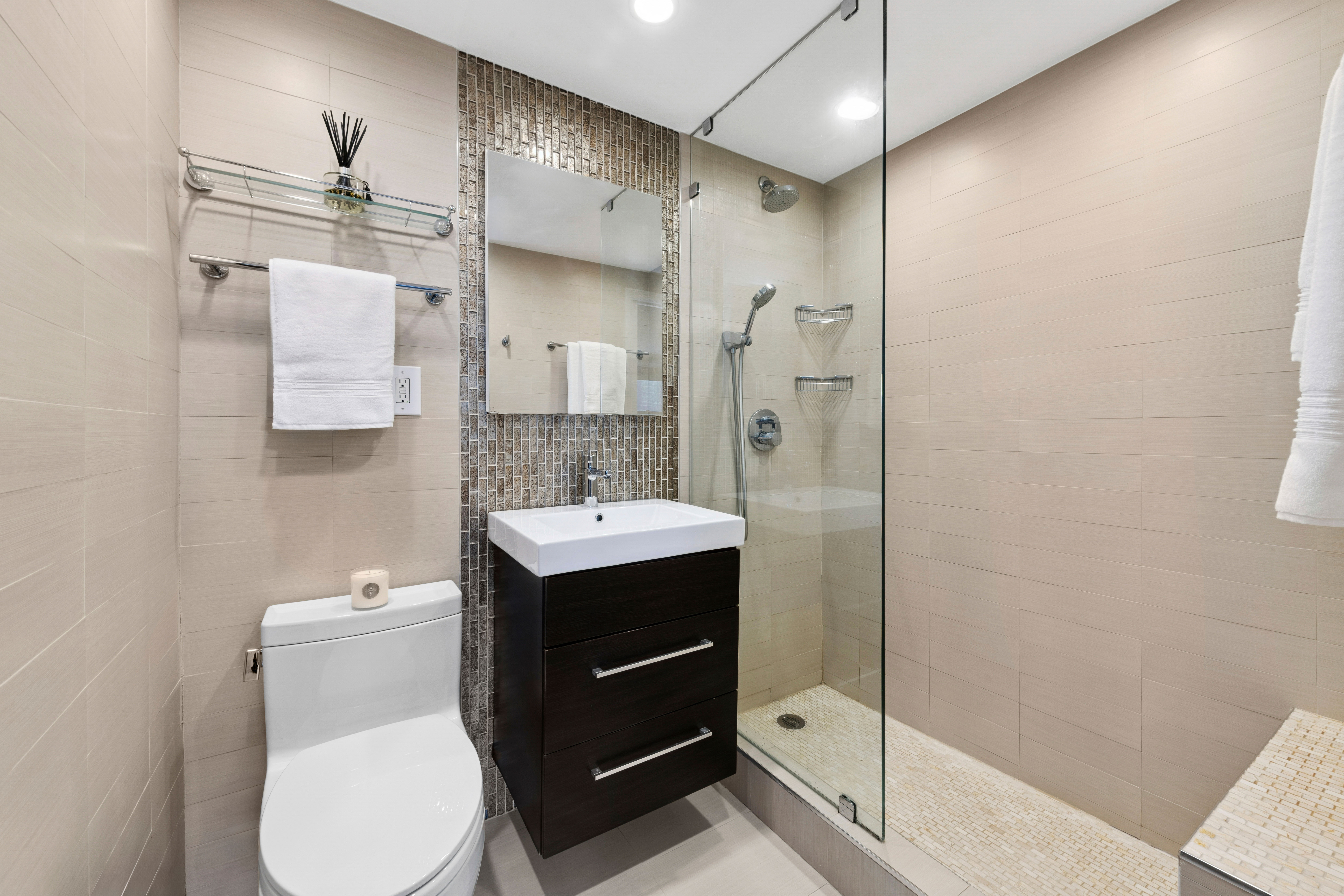 305 East 40th Street, Unit 19CD Manhattan, NY 10016 - Photo 11 of 16 a bathroom with a toilet sink shower and mirror