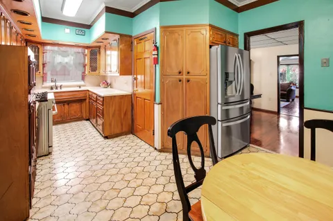 a kitchen with stainless steel appliances a refrigerator and a stove
