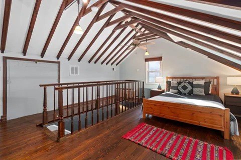 a bedroom with bed and a book shelf