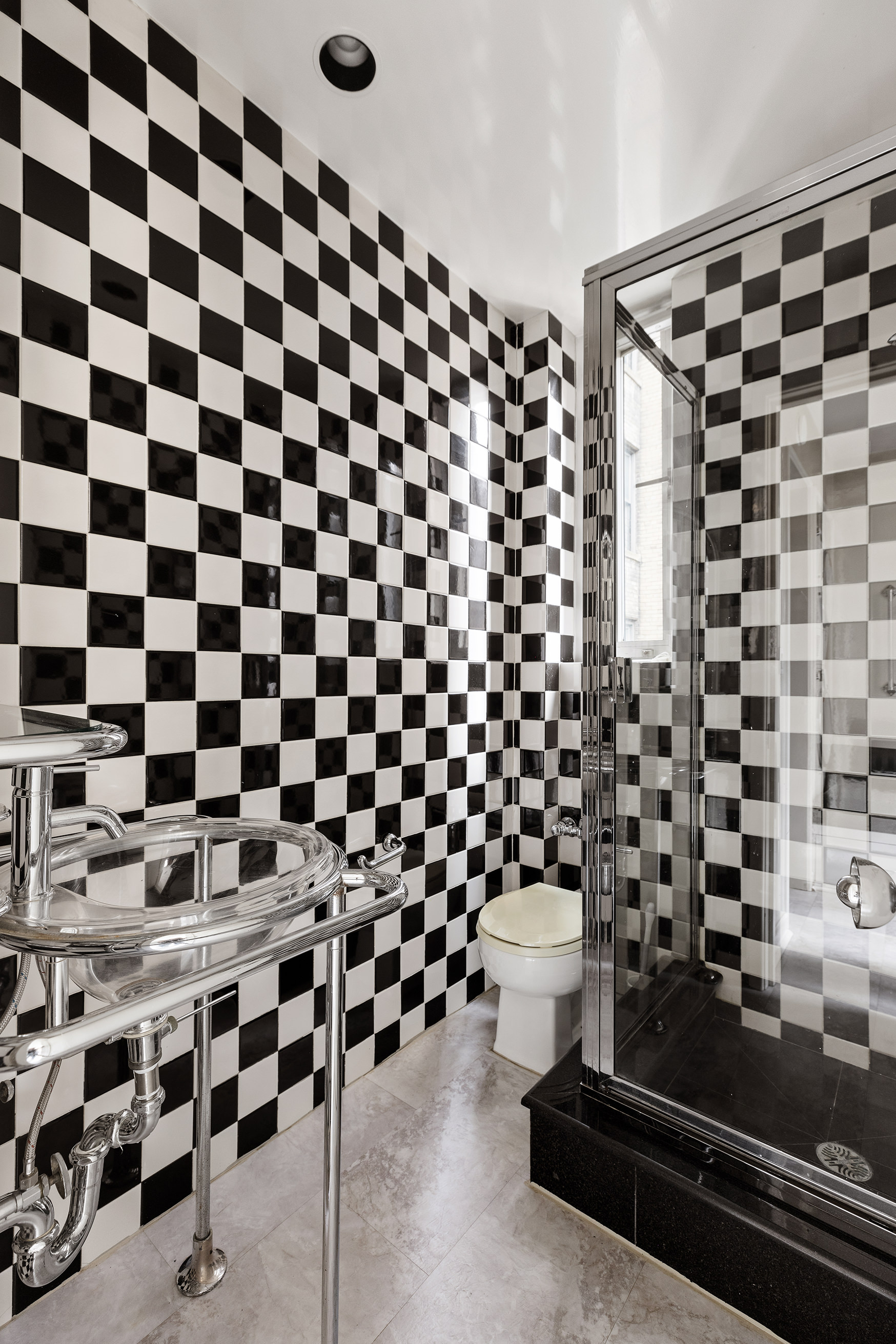 130 East 75th Street, Unit 4D Manhattan, NY 10021 - Photo 15 of 19 a bathroom with a black and white checkered floor