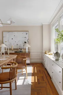 a kitchen with a sink and chairs