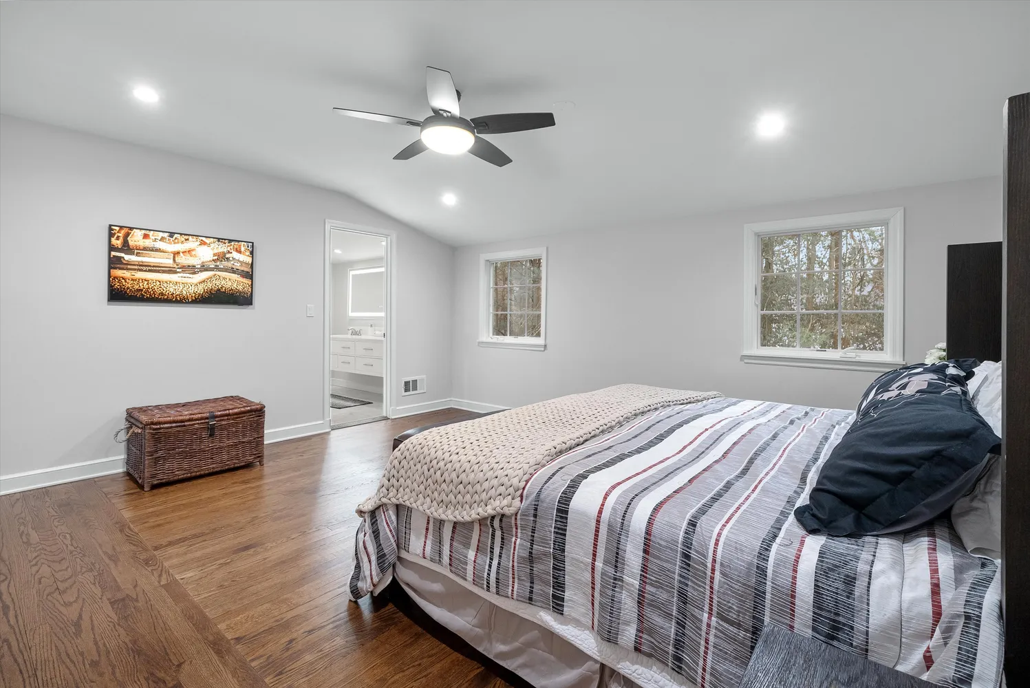 a bedroom with a bed and wooden floor