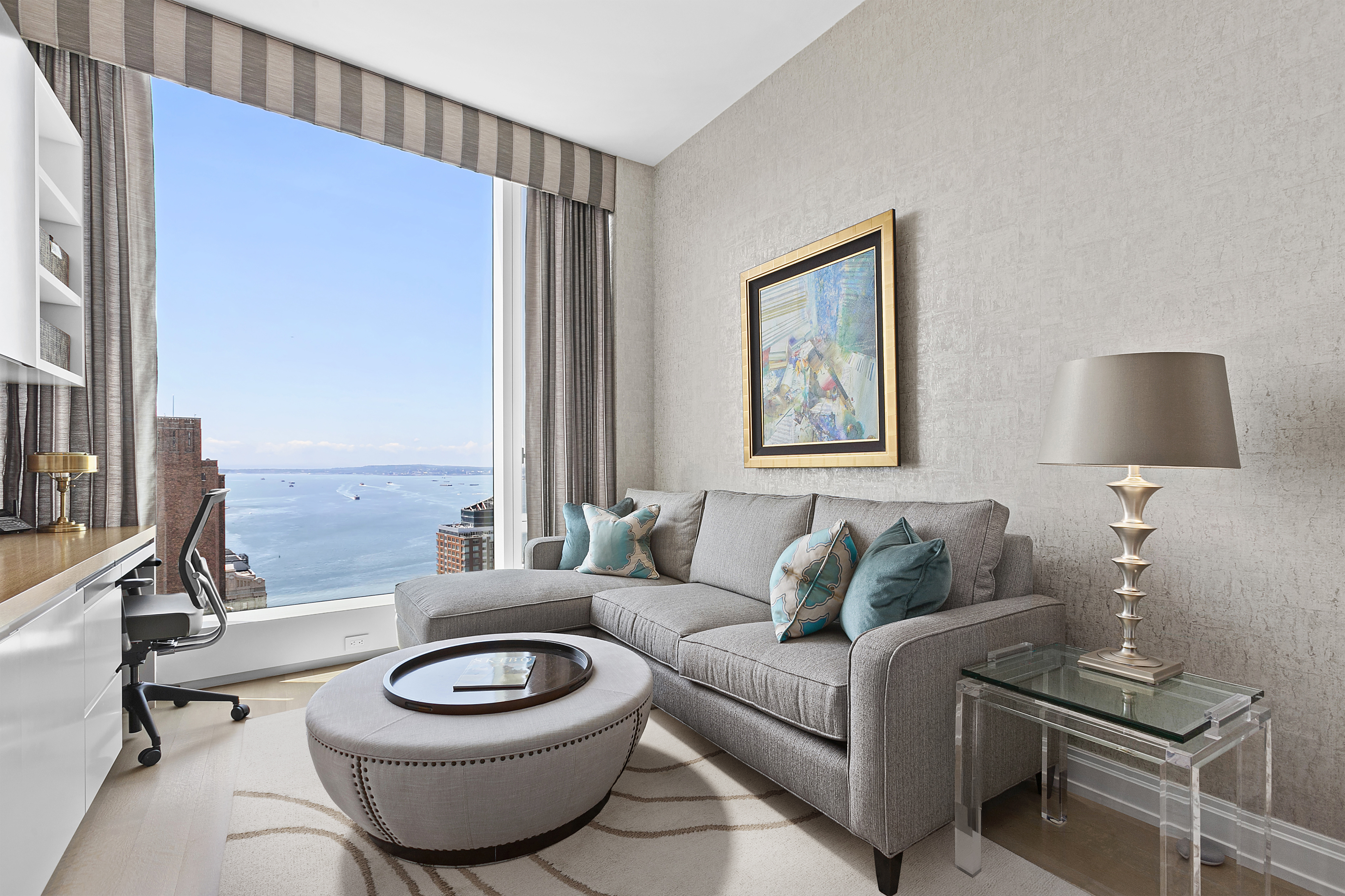 50 West Street, Unit 45B Manhattan, NY 10006 - Photo 6 of 8 a living room with furniture and a large window