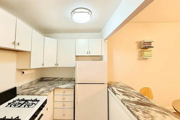 61 Lexington Avenue, Unit 4H Manhattan, NY 10010 - Photo 4 of 6 a kitchen with a refrigerator and a stove