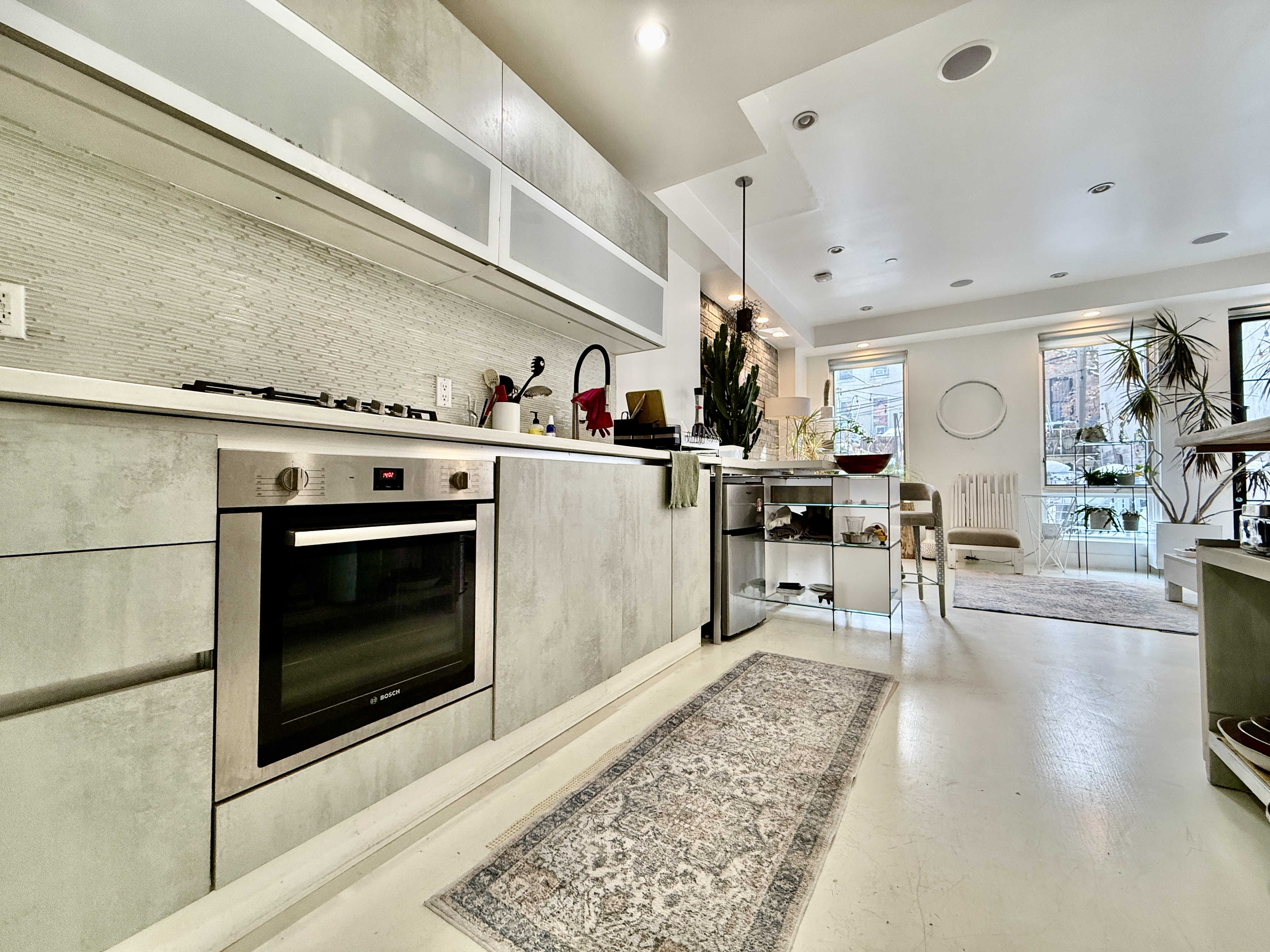 668 Halsey Street, Unit 1 Brooklyn, NY 11233 - Photo 6 of 14 a living room with stainless steel appliances furniture a rug and a fireplace