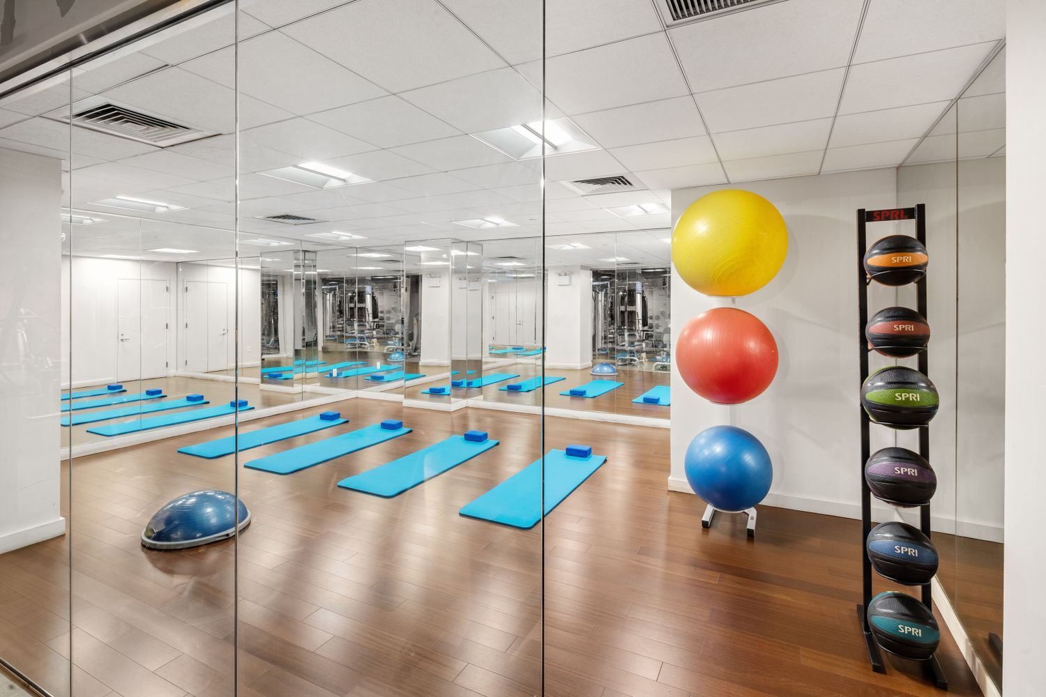 88 Greenwich Street, Unit 1218 Manhattan, NY 10006 - Photo 17 of 30 a kitchen with stainless steel appliances a dining table chairs and a chandelier