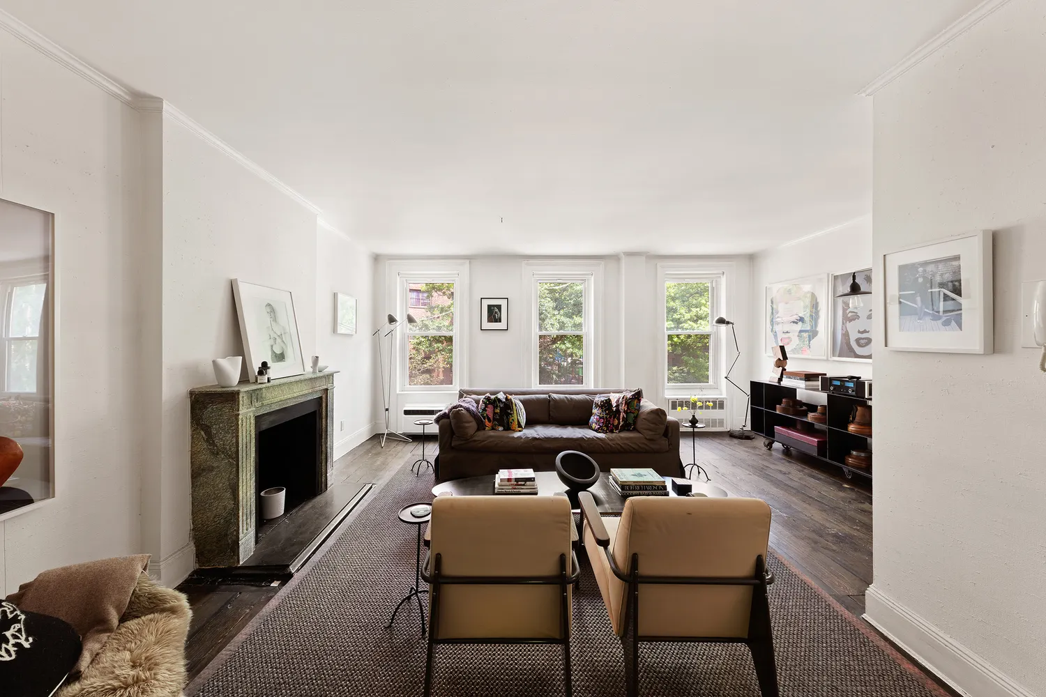 a living room with furniture fireplace and a window