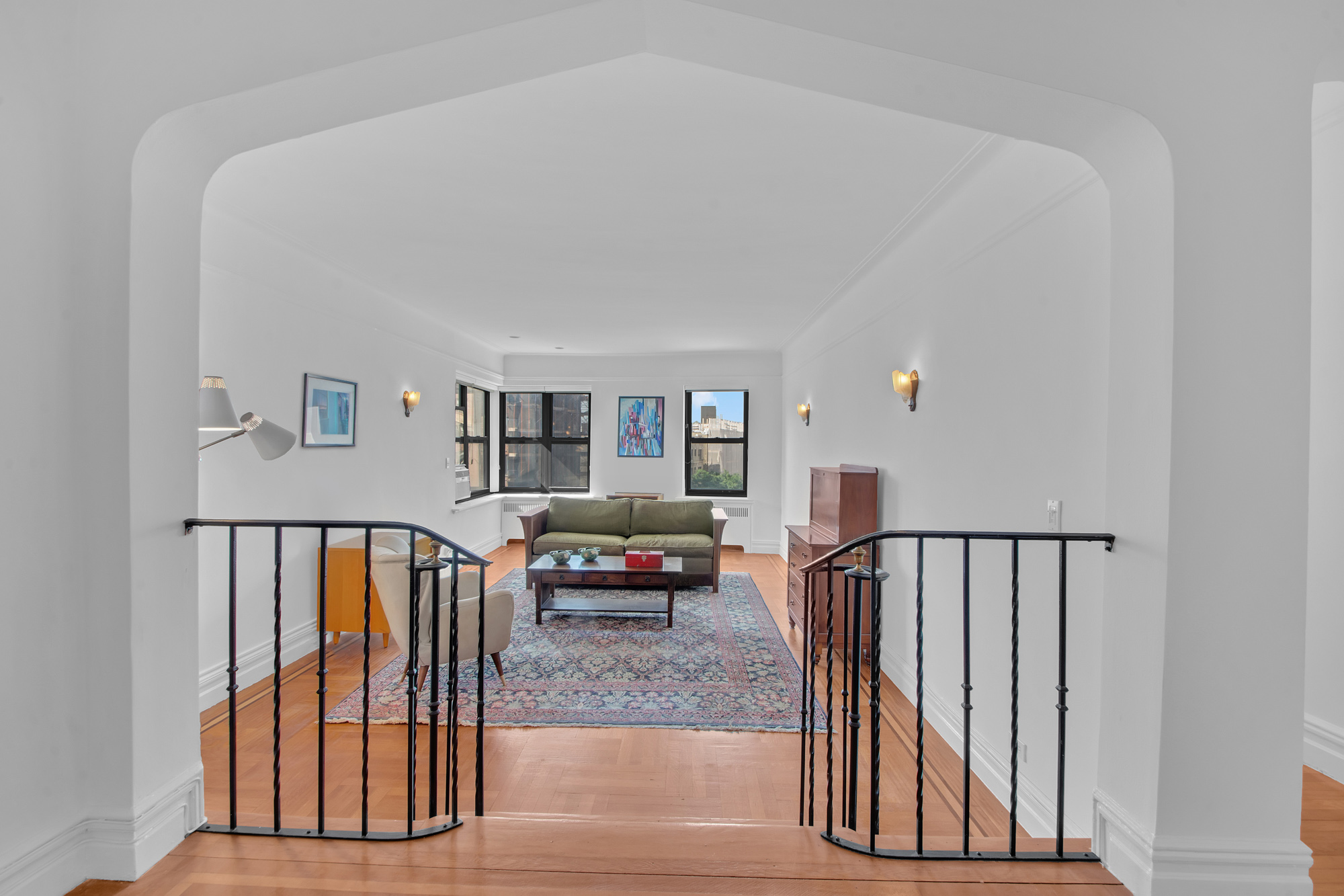 a view of a livingroom with furniture and staircase