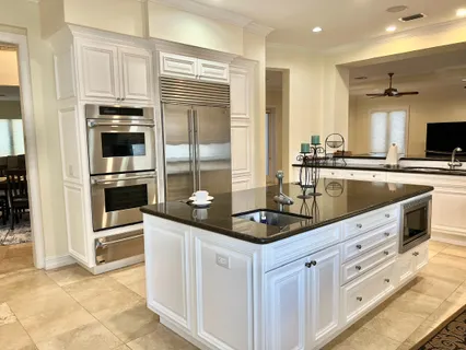 a kitchen with cabinets and stainless steel appliances