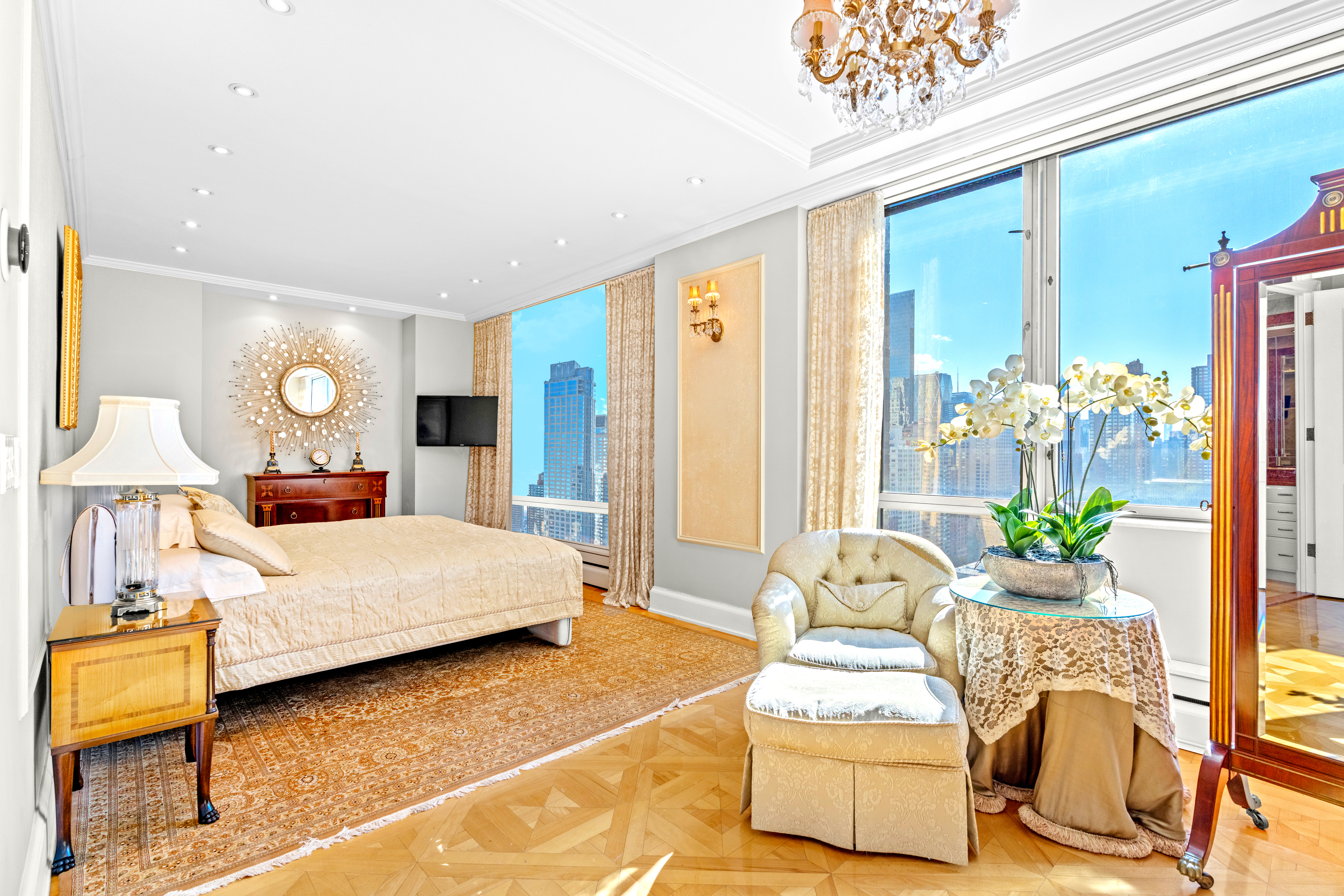 1965 Broadway, Unit 26EF Manhattan, NY 10023 - Photo 15 of 32 a living room with a bed furniture and a chandelier
