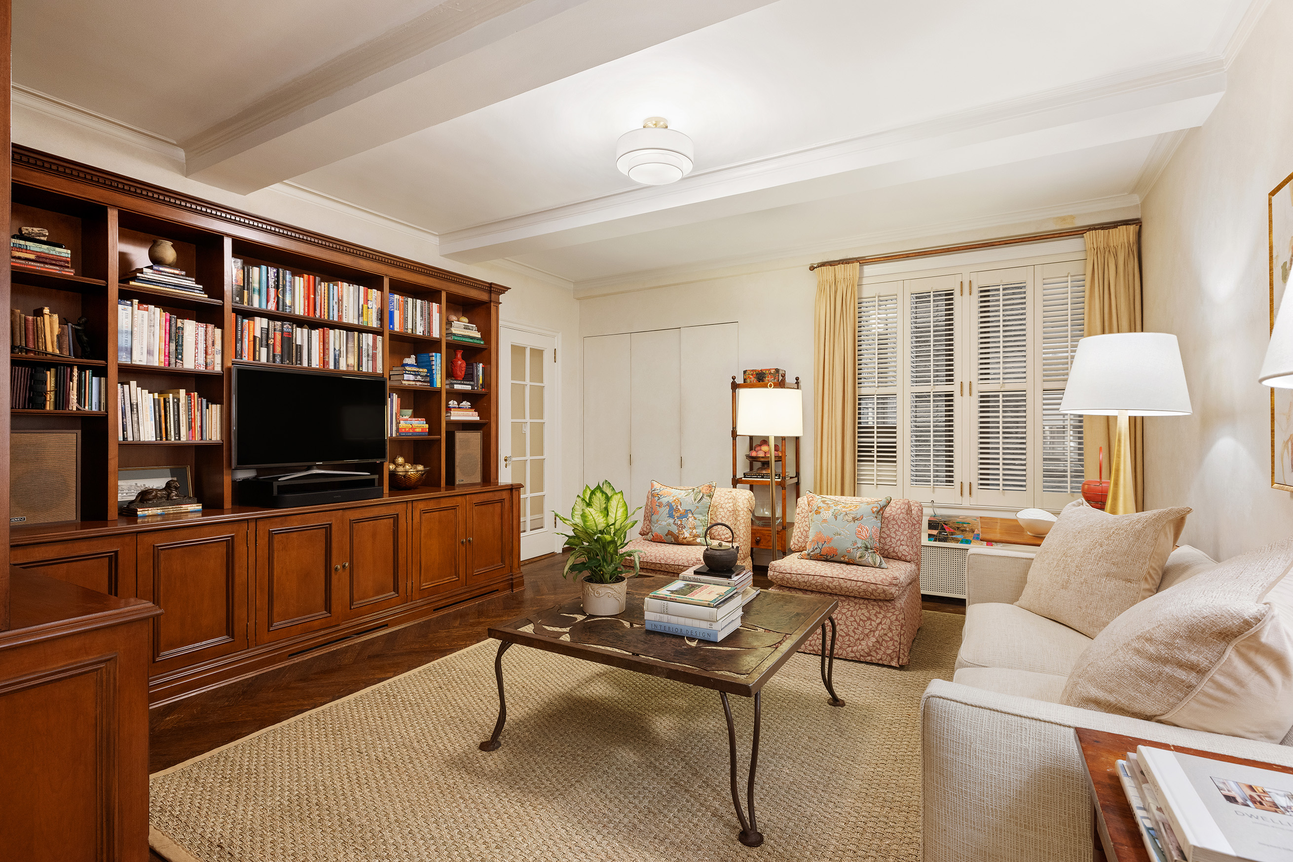 115 East 86th Street, Unit 22 Manhattan, NY 10028 - Photo 5 of 16 a living room with furniture and a flat screen tv