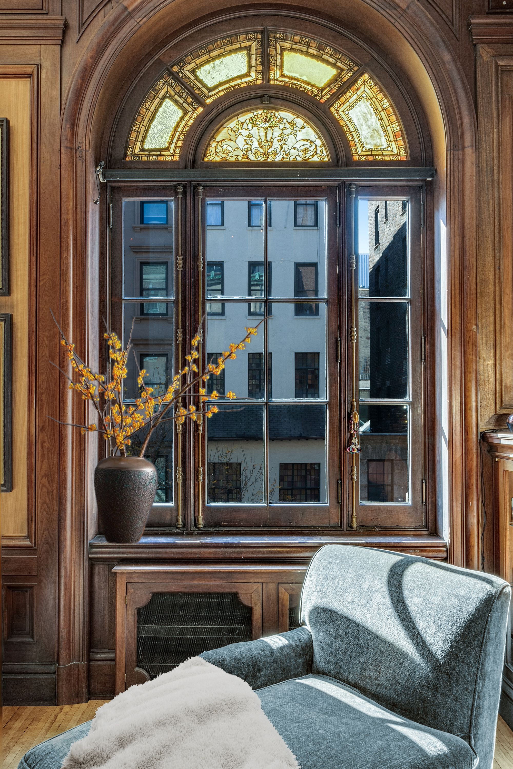 35 East 68th Street, Unit 2A Manhattan, NY 10021 - Photo 4 of 19 a living room with a couch and a large window