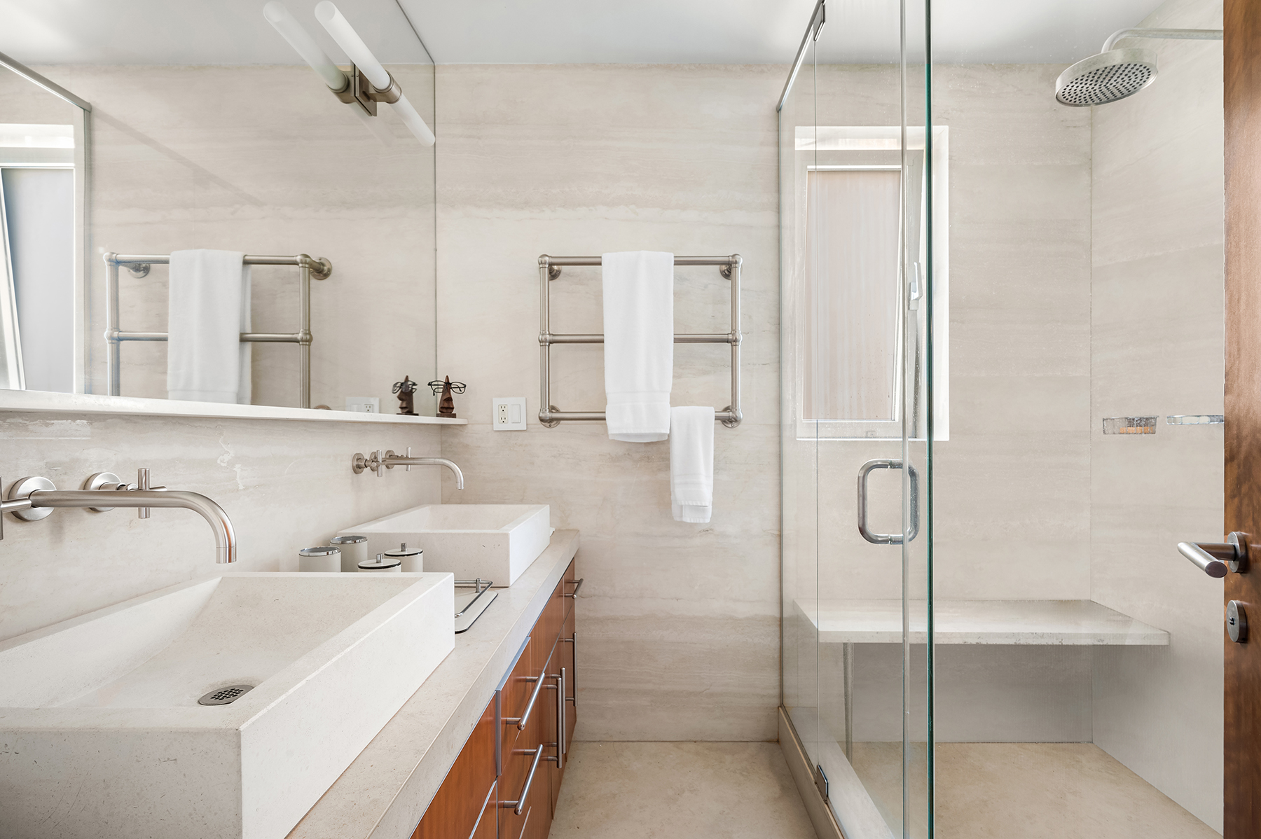 923 5th Avenue, Unit 15A Manhattan, NY 10021 - Photo 4 of 10 a bathroom with a double vanity sink mirror and shower