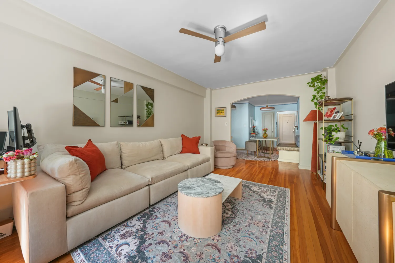 a living room with furniture and a wooden floor