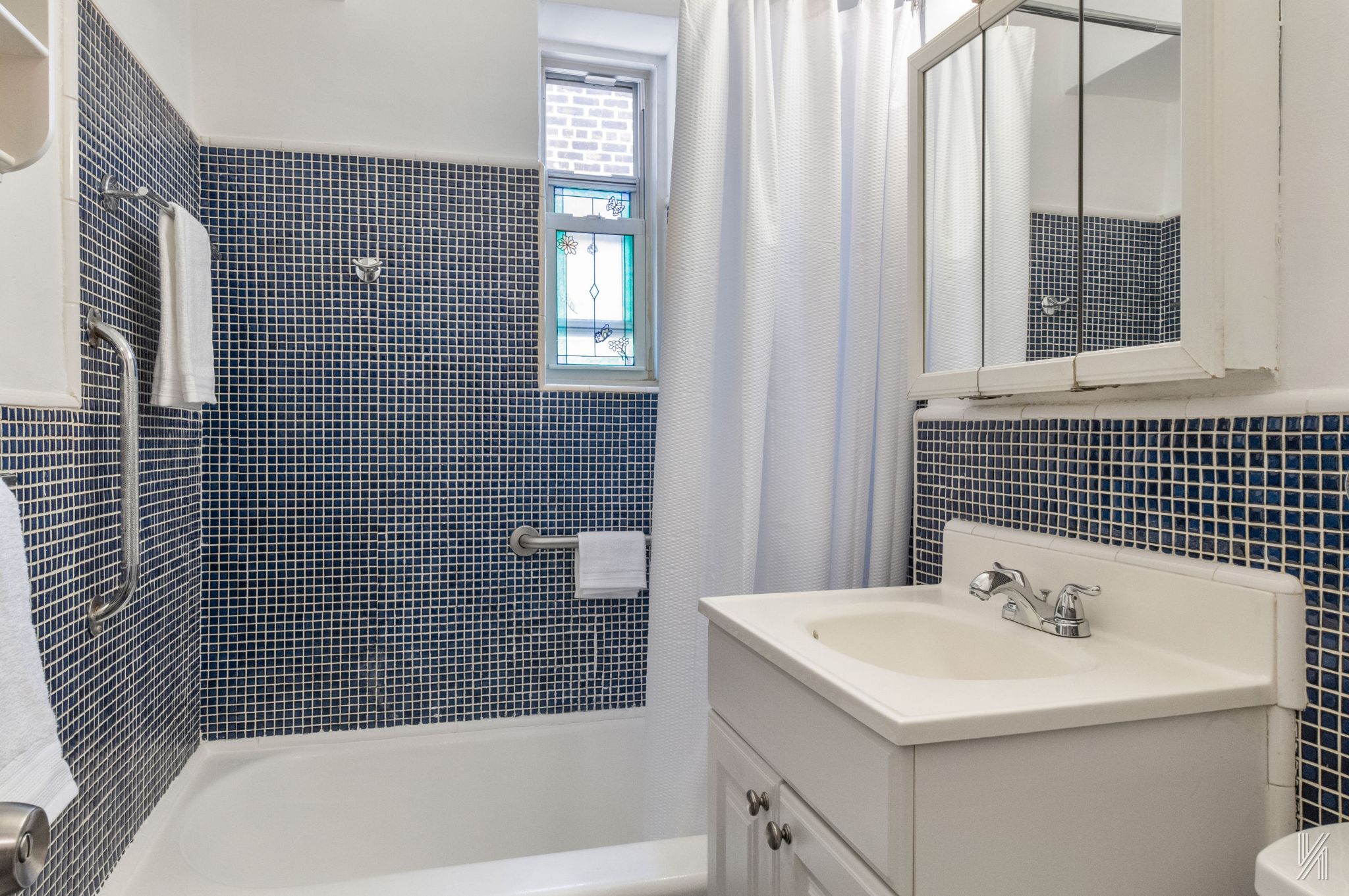 39-30 52nd Street, Unit 5E Queens, NY 11377 - Photo 13 of 15 a bathroom with a sink a toilet and shower