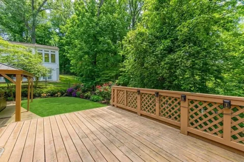 a backyard of a house with barbeque oven table and chairs