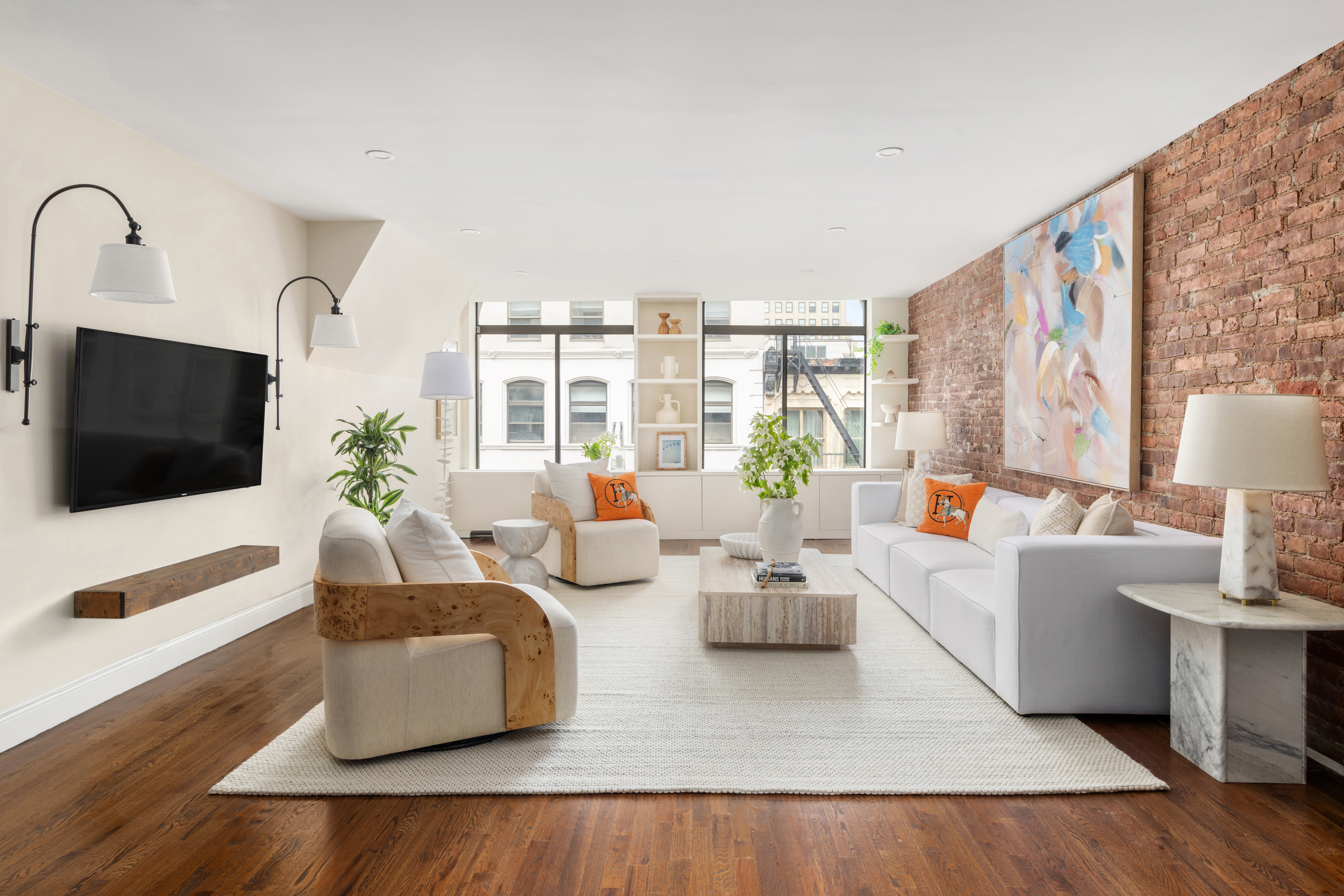 99 Reade Street, Unit 5E Manhattan, NY 10013 - Photo 2 of 13 a living room with furniture and a flat screen tv