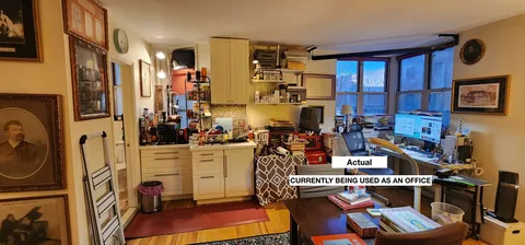 a view of a workspace with furniture and a kitchen