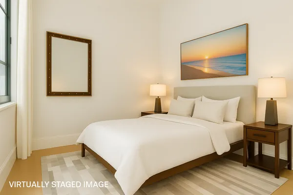a bedroom with a bed and a painting on the wall