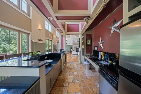 a kitchen with stainless steel appliances kitchen island granite countertop a stove and a refrigerator