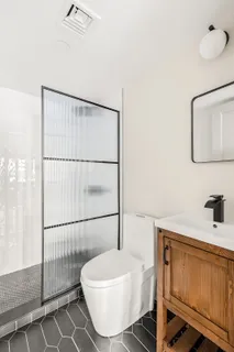 a bathroom with a sink toilet and shower