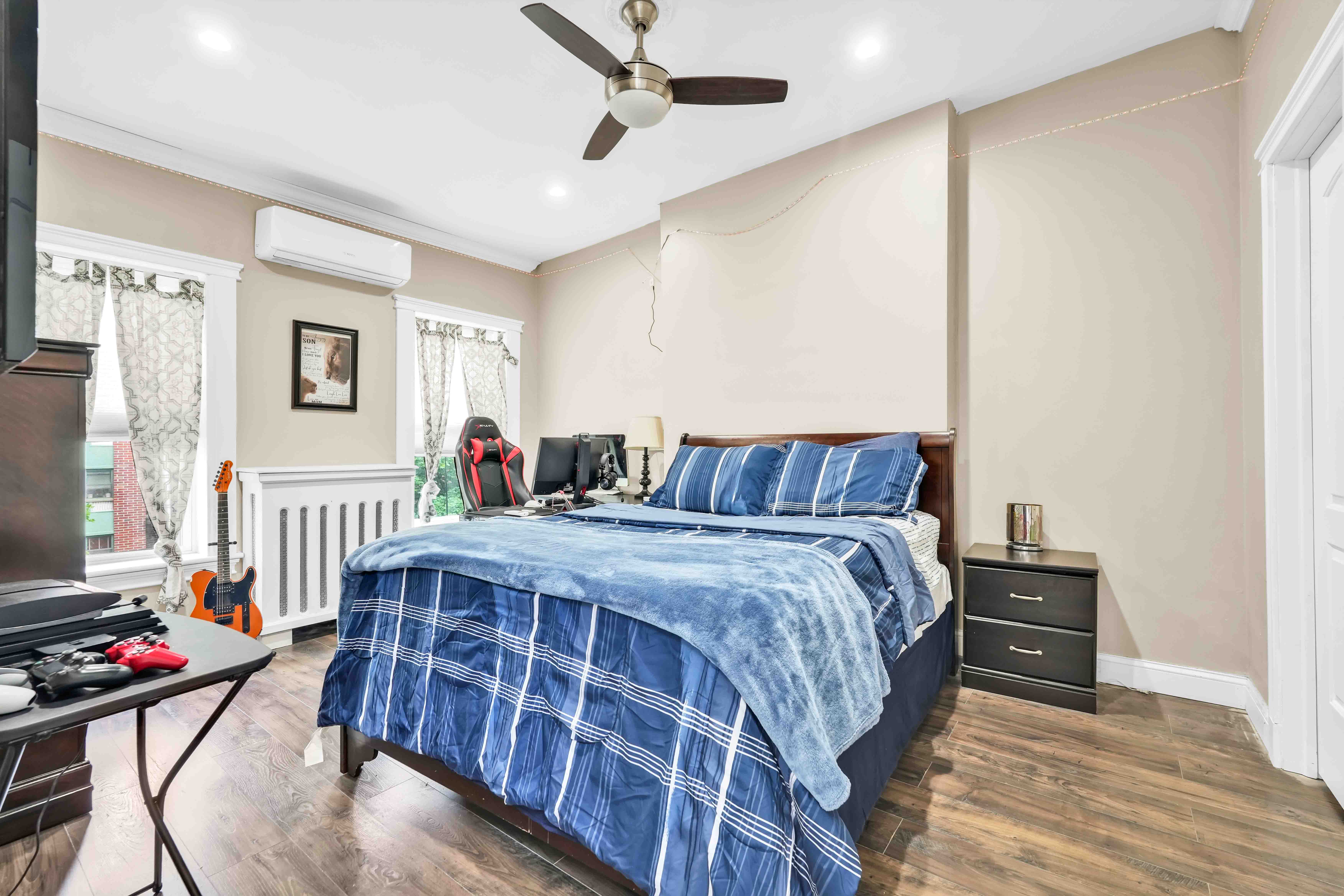 519 Monroe Street Brooklyn, NY 11221 - Photo 23 of 55 a bedroom with a bed and wooden floor