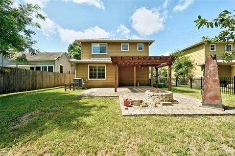a front view of a house with a yard table and chairs