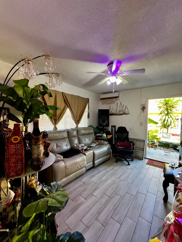 a living room with furniture and a floor to ceiling window